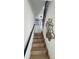 Modern staircase with wood treads, black metal railing, and unique wall art at 1472 Yates St, Denver, CO 80204