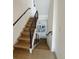 Stylish staircase with wood treads and dark railing leading to multiple levels at 1472 Yates St, Denver, CO 80204