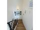 Elegant staircase featuring wood steps, a dark metal railing, and decorative wall art at 1472 Yates St, Denver, CO 80204