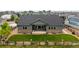 Backyard view of home with stone accents, a spacious lawn, and a charming wooden fence at 11259 Kalispell St, Commerce City, CO 80022