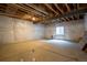 Unfinished basement with exposed beams and white plastic sheeting on the walls at 11259 Kalispell St, Commerce City, CO 80022
