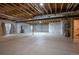 Unfinished basement with exposed beams and white plastic sheeting on the walls at 11259 Kalispell St, Commerce City, CO 80022