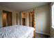 Bedroom featuring unique wooden bedframe and multiple entry ways at 11259 Kalispell St, Commerce City, CO 80022