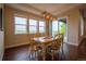 Bright dining area with hardwood floors, stylish lighting, and a sliding door that offers backyard views at 11259 Kalispell St, Commerce City, CO 80022