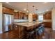 Gourmet kitchen features granite counters, stainless appliances, and large island with seating at 11259 Kalispell St, Commerce City, CO 80022
