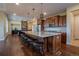 Spacious kitchen features a large island with seating, granite countertops, and stainless steel appliances at 11259 Kalispell St, Commerce City, CO 80022