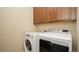Functional laundry room with modern appliances and storage cabinets for cleaning supplies and linens at 11259 Kalispell St, Commerce City, CO 80022