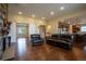 Large living room with hardwood floors, stone fireplace and open kitchen access at 11259 Kalispell St, Commerce City, CO 80022