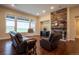 Cozy living room has hardwood floors, stone fireplace and large windows at 11259 Kalispell St, Commerce City, CO 80022