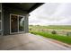 Covered patio overlooks a well maintained lawn and green space at 11259 Kalispell St, Commerce City, CO 80022