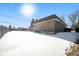 Back exterior view of home on snowy day at 1832 Simms St, Lakewood, CO 80215