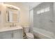 Updated bathroom features a modern vanity and a shower with beautiful marble-style tiling at 1832 Simms St, Lakewood, CO 80215