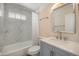 Updated bathroom features a modern vanity and a shower with beautiful marble-style tiling at 1832 Simms St, Lakewood, CO 80215