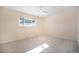 Spacious bedroom with neutral carpet, ceiling fan, window, and access to ensuite bathroom at 1832 Simms St, Lakewood, CO 80215
