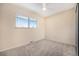 Neutral carpeted bedroom with ceiling fan, closet and window at 1832 Simms St, Lakewood, CO 80215
