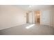 Large bedroom featuring neutral carpet, ceiling fan, and entry to ensuite bathroom at 1832 Simms St, Lakewood, CO 80215