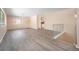 Open living room with gray vinyl flooring and a staircase at 1832 Simms St, Lakewood, CO 80215