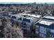 Apartment complex with a brick and grey exterior, balconies, and mountain views in the distance at 1489 Steele St # 310, Denver, CO 80206
