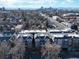 Apartment building complex with city skyline in the distance amid a beautiful residential neighborhood and road at 1489 Steele St # 310, Denver, CO 80206