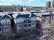 Apartment building with balconies and a brick and gray siding exterior and cityscape view at 1489 Steele St # 310, Denver, CO 80206