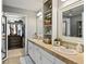 Bright bathroom with double sinks, tiled floor, and a closet behind the left door at 1489 Steele St # 310, Denver, CO 80206