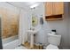 Small bathroom with a pedestal sink, neutral tile, and a shower over tub with a curtain at 1489 Steele St # 310, Denver, CO 80206