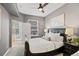 Relaxing bedroom with a black headboard bed, soft carpet, and french doors to a balcony at 1489 Steele St # 310, Denver, CO 80206