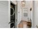 Bright entryway with hardwood floors, console table, hanging wall decor, and stacked washer/dryer at 1489 Steele St # 310, Denver, CO 80206