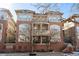 Chamberlin Heights features a red brick facade with multiple balconies and symmetrical windows, offering a classic and inviting look at 1489 Steele St # 310, Denver, CO 80206