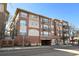 Chamberlin Heights showcasing the red brick facade, multiple balconies, and convenient underground parking at 1489 Steele St # 310, Denver, CO 80206