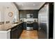 The kitchen features stainless steel appliances, granite countertops, and subway tile backsplash at 1489 Steele St # 310, Denver, CO 80206