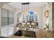 Open-concept kitchen area with stainless steel appliances, pendant lighting, and dining room view at 1489 Steele St # 310, Denver, CO 80206