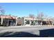Local neighborhood businesses with brick exteriors and storefront windows on a sunny day at 1489 Steele St # 310, Denver, CO 80206