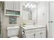 Bright bathroom with white vanity and large mirror at 13606 E Bates Ave # 208, Aurora, CO 80014