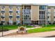 Building exterior, showcasing landscaping and building number 202 at 13606 E Bates Ave # 208, Aurora, CO 80014
