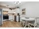 Eat-in kitchen with white cabinets, stainless steel appliances, and a small table at 13606 E Bates Ave # 208, Aurora, CO 80014