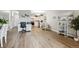 Open living area featuring wood-look floors and a view of the kitchen at 13606 E Bates Ave # 208, Aurora, CO 80014