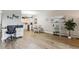 Living room with wood-look floors, a view of the kitchen, and access to a balcony at 13606 E Bates Ave # 208, Aurora, CO 80014