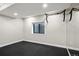 Finished basement featuring black rubber flooring and an exercise area with pull-up bar and mirrors at 4445 Wolff St, Denver, CO 80212