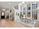 Elegant dining room with soaring ceilings, large windows, a modern chandelier, and a statement rug for added style at 4445 Wolff St, Denver, CO 80212