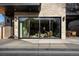 Contemporary home's exterior featuring large windows, inviting patio, and an outdoor dining area with seating at 4445 Wolff St, Denver, CO 80212