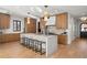 Spacious kitchen featuring a white island with seating, custom wood cabinetry, and stylish pendant lighting, perfect for gatherings at 4445 Wolff St, Denver, CO 80212