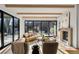 Sun-filled living room features wood beams, hardwood floors, and a cozy fireplace with designer furnishings at 4445 Wolff St, Denver, CO 80212