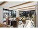 Inviting living room with wood beams, hardwood floors, fireplace, and seamless access to a gorgeous outdoor space at 4445 Wolff St, Denver, CO 80212