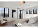 Bright main bedroom featuring vaulted ceilings, French doors, hardwood floors and stylish modern decor at 4445 Wolff St, Denver, CO 80212