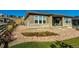 Home exterior view featuring stone accents, landscaping, a well-kept lawn, and covered patio space at 7334 Canyonpoint Rd, Castle Pines, CO 80108