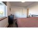 Well-lit bedroom with hardwood floors, a dresser, and a closet, offering a cozy and functional space at 801 S Shoshone St, Denver, CO 80223