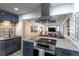 Open kitchen with modern appliances, granite countertops, and a view into the living area at 801 S Shoshone St, Denver, CO 80223