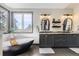 Modern bathroom with a freestanding tub, dual vanities, and stylish fixtures at 5352 Pinyon Jay Rd, Parker, CO 80134