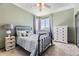 Bedroom with a wrought iron bed, light-colored walls, and window views at 5352 Pinyon Jay Rd, Parker, CO 80134